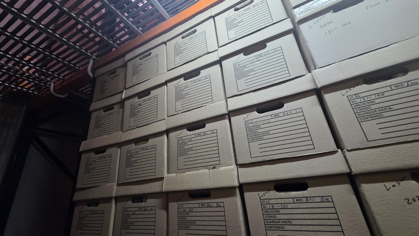 Cajas de archivo rotuladas y ordenadas en estantería, después de la intervención de SOS Archivos